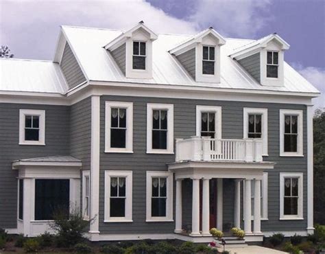 white house with dark grey metal roof|houses with white metal roofs.